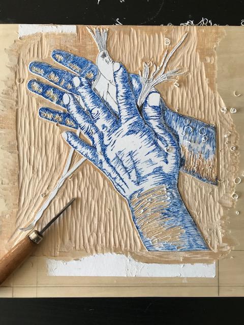 carving of blue hands on wood